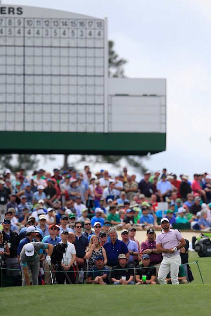 Jason Day (right) endures a balky back to shoot 67 and grab a share of the midway lead in the Masters.